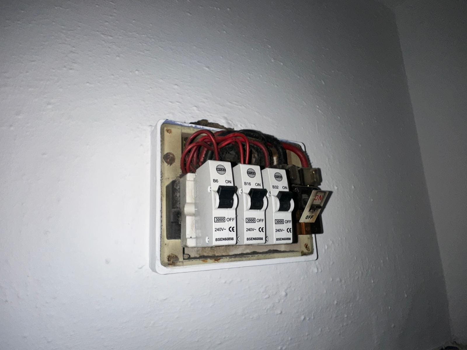 Electrician terminating cables inside a consumer unit